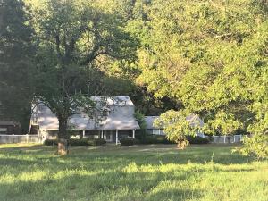 Large home perfect for a large family! Clear Creek runs through the property and also has a year round spring. 1280 square foot shop building has tall ceilings and a bathroom. There are also two RV spots by the building with own septic system. Lots of wildlife.