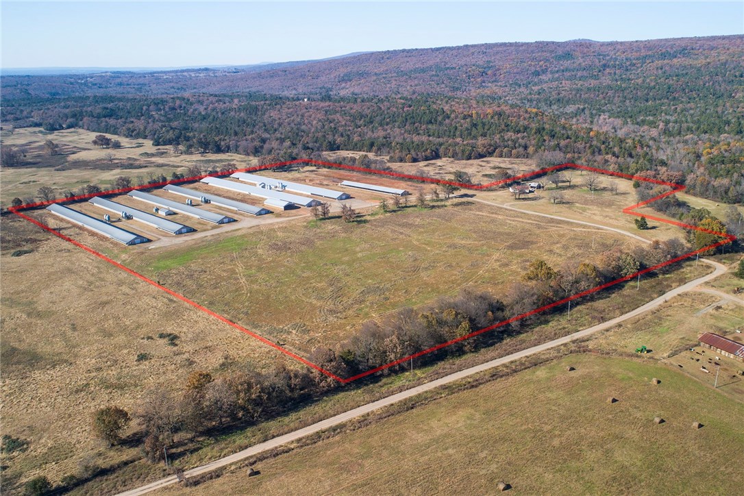 This is a NICE farm! 4 2007 built 43x510s and 2 2018 built 54x550s for an annual income about $375,000. Some of the building incentive still remains. Farm is on natural gas and has public water to backup 5 wells. The stacking shed is just six months old. The 40 acres is open and level with productive pasture. The double wide is in good condition and has a workshop as well to keep tools and do repairs. We are pleased to offer this fine farm with an OK Foods contract in this peaceful country setting!