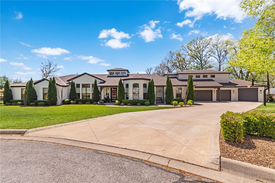 A masterpiece of luxury living in NWA’s Premiere Golf Course Community Pinnacle Subdivision. 
Meticulously remodeled, 5 bedrooms, 4 full bathrooms, 4-car garage, golf cart parking & game room on the main level. 2nd Level Bonus room boasts 4 full-size built-in bunk beds. Walk through the iron front door into an immaculate open floor plan, the skylight & exposed beams let natural light flood in. The kitchen’s oversized island & charcoal soapstone countertops, RIAD tile backsplash, soft-close cabinetry, Monogram appliances & walk-in pantry are a chef’s dream. Calcutta gold stone counters, 91-bottle dual temp. control wine cooler & modern fixtures elevate the formal dining room. The primary suite has a double-sided fireplace, stand-alone soaking tub & spacious walk-in closet. Vibe with friends in the game room w/ pool table & wet bar. Enjoy a massive outdoor space secluded by 70 trees planted on the .77 acre lot for privacy around the heated pool, built-in trampoline, 2 fire pits & covered patio spaces.