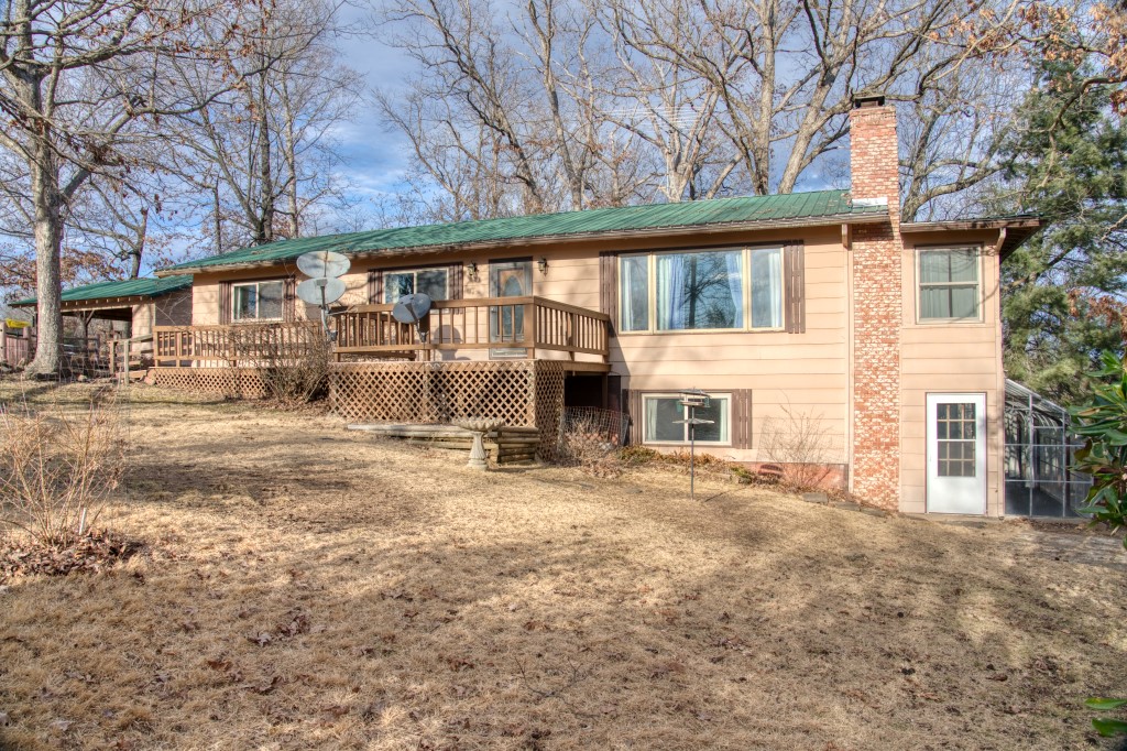 This is the perfect opportunity to relocate to Beaver Lake and put your personal touch on your new home! Both the upper and lower levels have lots of windows to enjoy the great view. A sunroom on each level almost brings nature inside! Two large living rooms give you room for family and guests. A carport and a garage have room for your vehicles and toys! This end of the street location means hardly any traffic and a peaceful setting. Starkey Marina and the White River are easy to get to and all the amenities of Eureka Springs are close by!