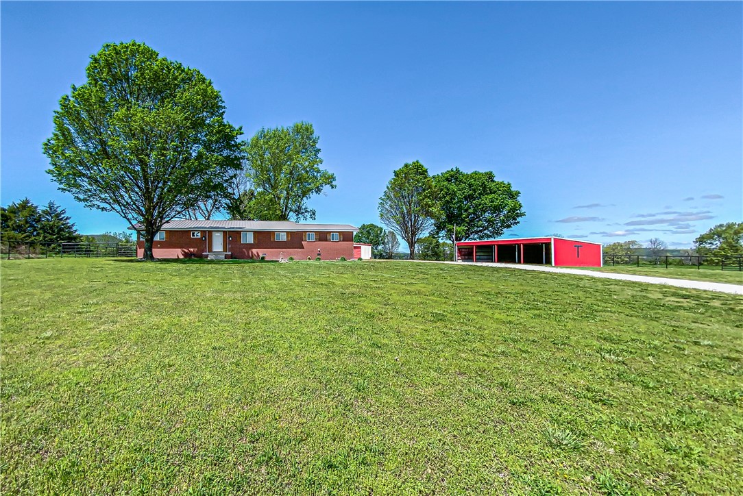 Escape to your own private sanctuary! This 3 bed, 2 bath home boasts breathtaking hilltop views from its almost 25 acres of serene pasture land with lots of welded pipe fencing. Enjoy privacy at the end of a road and barely off of the pavement, complete with a barn, red iron shop, and equipment shed. Convenient to town, yet worlds away.