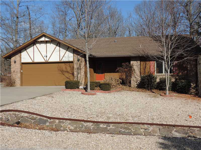 Glassed Wall of Windows=Sunroom brings wooded outdoors inside,Bentonville Schools Possible!Enjoy warm fireplace,Huge living area,Kitchen=Corian counters custom hardwood cabinets,Tiled floors kitchen,baths & entry,2 Lg bdrms,2 baths oversized 2 car garage,flat driveway,new HVAC,beautiful flowering bushes adorn entry,attic fan.Cedar exterior,leaded glass front door,refrigerator Wshr&Dryr stay,WIC,wood dbl pane windows,nice backyard,convenient location,SEWER,FP thermostatically controlled,Garage 25'3 x 21'6.