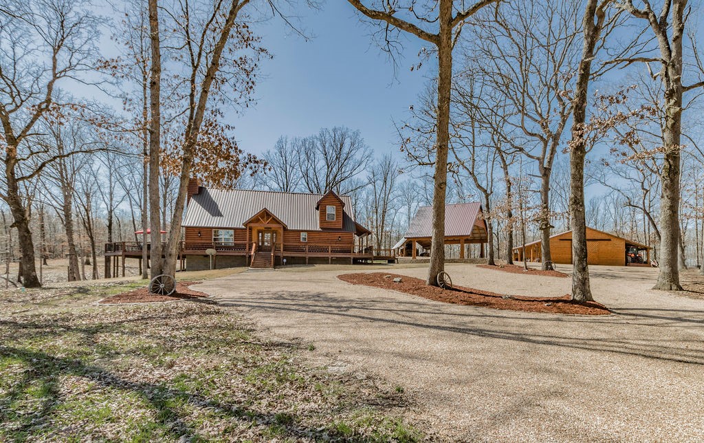Over 583 acres of hunting paradise, affectionately known as Turkey Ridge. Just 15-20 minutes from Bentonville, you won't find this many acres this close to town anywhere else. Gated entry and paved road access. The 1,848 Square Foot lodge has 3 bedrooms and 3 full baths, a beautiful open kitchen and bar, Meat hanging walk-in cooler, and a full wrap around deck. 16x16 Outdoor Kitchen pavilion with wood fireplace. Covered parking for 2+cars. AND a 30x40 wooden barn/shop. Greater property features several active springs providing year round live water. Expansive road system not usually seen on hunting land - Easily drive a 4WD vehicle throughout the property (see attached map and photos). Lots of frontage on Kelly Pond Rd.