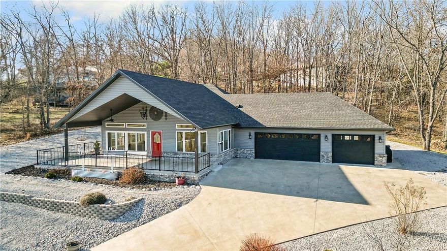 Be the envy of the neighborhood with this stunning custom-built home overlooking the Scotsdale Golf Course. A dramatic wall of windows frames breathtaking fairway views and fills the open-concept living space with natural light, creating a seamless connection to the Ozarks’ beauty. The enormous covered patio offers the perfect vantage point to relax and take in the scenery year-round. Wooden laminate flooring flows throughout with luxurious tile in the wet areas, complemented by abundant built-ins that add charm and function. The luxurious primary ensuite features a spacious walk-in shower and exquisite clawfoot tub, while a second oversized bedroom provides comfort for guests. A three-car garage includes a third bay transformed into a versatile bonus room with its own mini-split (not included in square footage), easily converted back if desired. Situated on two landscaped lots totaling over half an acre, this low-maintenance property is the pinnacle of character and craftsmanship.