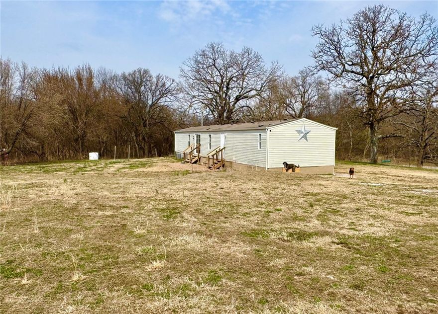 This well-maintained 3BR/2BA property offers comfort, functionality, & room to live both inside & out. W/updates & improvements throughout, this home is ready & ideal for those wanting space for hobbies, animals, or country living. It also has the best views of breathtaking AR sunrises & sunsets. Inside, you'll find numerous recent upgrades incl: Guest bath vanity & vinyl flooring, new vinyl flooring in spare bedroom ('24), Walk-in pantry conversion ('25), Ensuite remodel featuring hardwood floors & added W/D ('25). Outside, enjoy the improvements: New back stairs ('26), Home has public water while well is currently used for livestock & agri purposes & new elec service at the pole. Animal lovers & hobby farmers will appreciate the setup: 8x16 chicken coop w/run & power, addl livestock run, storage shed & car port. This property offers the perfect blend of living space & outdoor amenities. If you're looking to expand your homesteading dreams or enjoy a property w/versatility & storage, this one checks the boxes.