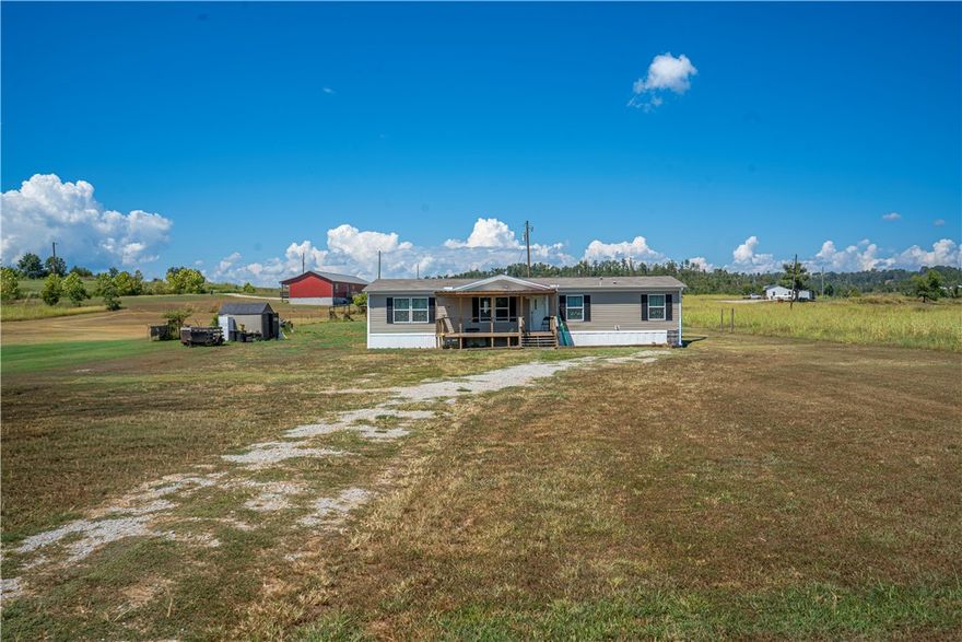 Country living with a creekside twist! This 4 bedroom, 2 bathroom doublewide sits on 1.42 peaceful acres just steps from Crooked Creek- perfect for fishing, floating, or simply relaxing. Enjoy the open floor plan, plenty of natural light, and space for the whole family! The property includes outbuildings for storage or hobbies, plus a storm shelter for peace of mind! All nestled in a quiet country setting, yet just a short drive to town! Did I mention the mobile home is a smart home?? You can control your thermostat from other states!