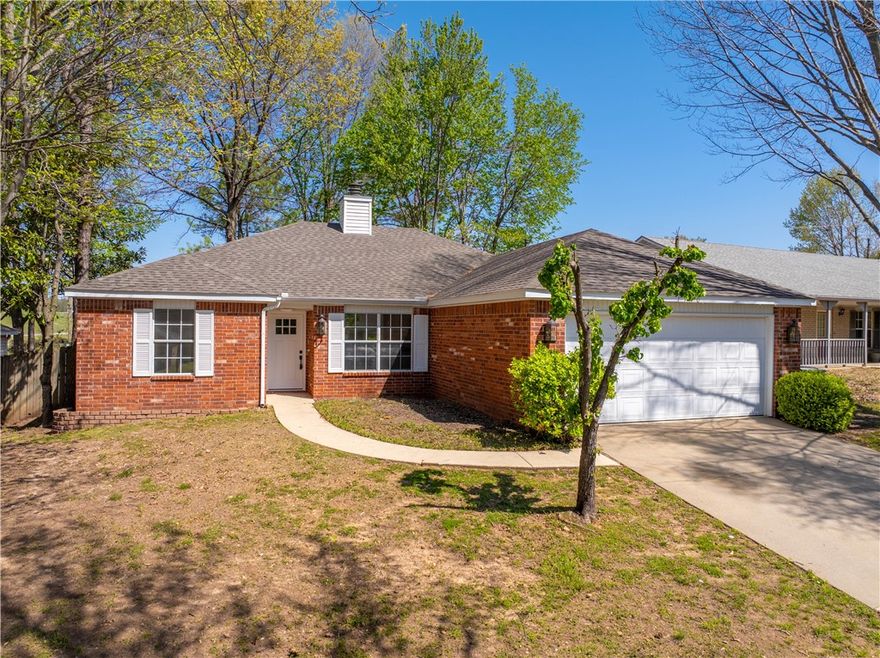 Conveniently located in walking distance to Tyson Foods headquarters and 71B, this charming home features a split floor plan with new LVP flooring in the living room and bedrooms. A dual-sided fireplace adds warmth and character, perfectly positioned for both living and dining areas. Step outside to a fenced-in yard with a back patio—ideal for relaxing or entertaining. Just minutes from shopping, dining, and everything Springdale has to offer, this home blends comfort, style, and a great location!