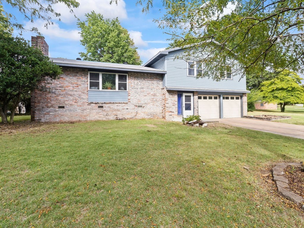 Charming home in the North Heights Subdivision! This tri-level home has all the room you family could need. Large picturesque window allows for an abundance of natural light and wood-burning fireplace in living room provides a warm ambience. Wrap around counter with bar seating area with plenty of cabinets and counterspace in eat-in kitchen. Updated with fresh paint and all new flooring throughout. Nestled on corner lot in established neighborhood. Wonderful large yard has open deck to relax and unwind after a long day. Centrally located close to all that NWA has to offer with the Jones Center just minutes away. Come check this one out today!