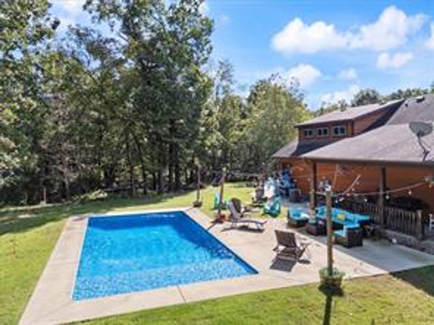 Welcome to your private retreat just minutes from town! This spacious 4BR/3BA home sits on 10 +/- secluded acres, offering the perfect blend of comfort, convenience, and luxury. Inside, you’ll find a thoughtfully designed layout featuring a bonus room ideal for entertaining, a dedicated office for remote work or study, and a walk-in pantry with easy kitchen access. A built-in mud area adds everyday functionality, while the in-home safe room provides added peace of mind. Interior walls are insulated for soundproofing and energy efficiency, complemented by radiant floor heating throughout. Step outside to enjoy your own in-ground mineral pool—perfect for low-maintenance relaxation. Additional or less land available.