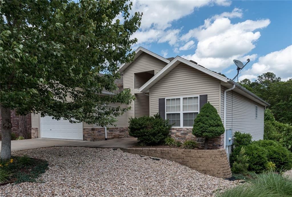 Immaculate 2 level home available in Bella Vista. This home opens up to a large living space with high ceilings. Spacious eat in kitchen with granite counter tops and ample cabinet space for plenty of storage. This home offers two bed and 2 baths on the main level and another bedroom and full bath and bonus room that could be a 4th bedroom in the finished, walkout basement. Enjoy the private views from the screened in porch. The walkout basement also features a large unfinished workshop/storage area. This home is on the Bella Vista sewer connect list and will need to be converted at closing. This house is a must see. Make your appointment today! Previous buyers financing fell through.