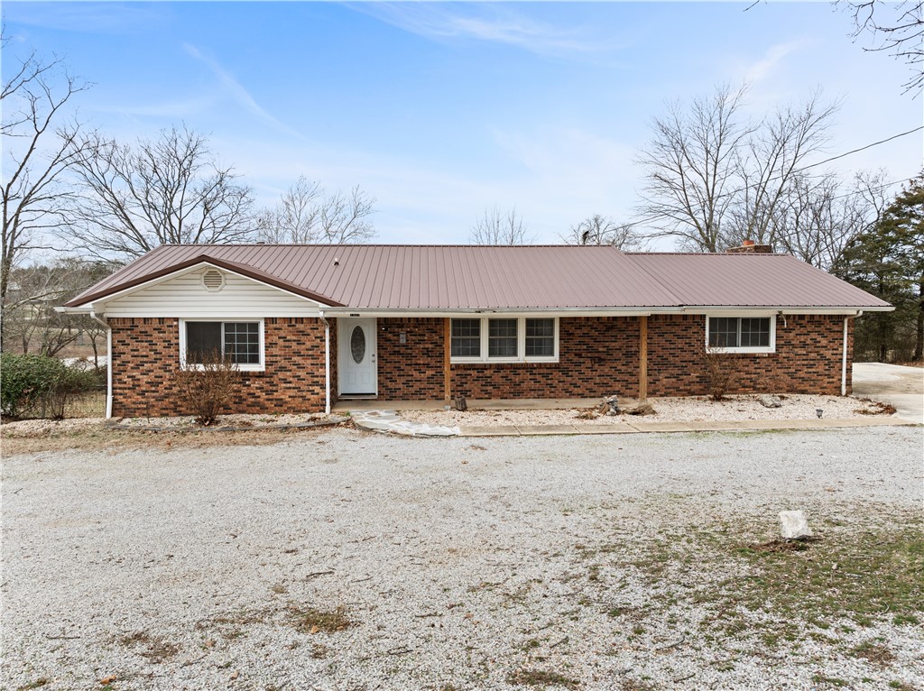 Searching for a spacious home that includes a separate living area for a mother-in-law suite or rental income? Look no further! This stunning brick home is located in town while still providing a peaceful, countryside vibe. Nestled on nearly an acre of land, this property features a private backyard. The main level boasts four bedrooms and two bathrooms, while the finished basement offers an additional two bedrooms and one bathroom. Plus, there's an unfinished 30 x 30 workshop in the back, ready for your personal touch! Enjoy summer days on the expansive covered deck or take a dip in the above-ground pool.