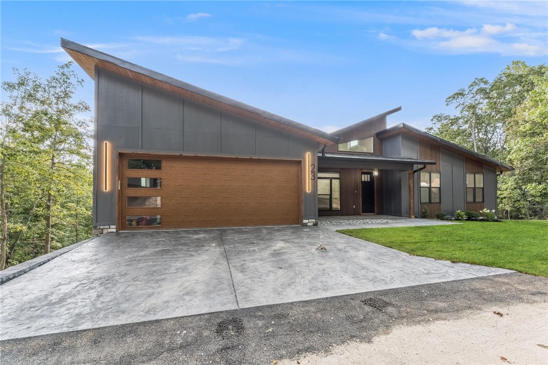 Come home to this truly remarkable modern home with seasonal views of Lake Windsor. Featuring unparalleled craftsmanship, custom trim features throughout, a spacious and open floor plan, 23 Wembly was designed to impress. The soaring ceilings and plentiful windows of the main level offer expanded natural light, while the custom features of the chefs kitchen will delight the senses. A second downstairs living room and kitchenette offer expanded options for living space. Offered below the recent appraisal of $850,000. Just steps away from local mountain bike trails and Lake Windsor. Come see this Bella Vista show stopper today.