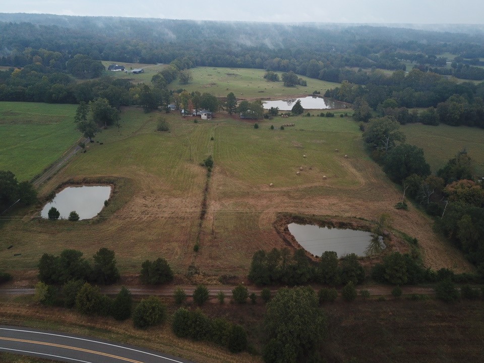 This 43-acre tract features expansive pasture, three stocked ponds, and dramatic mountain scenery.
The completely fenced estate includes a large workshop, a pole barn and a pump house with added storage space. A back deck offers a tranquil vantage point to take in the green pastures and mountain views. The mobile home has been expanded and provides three bedrooms and 2.5 baths, with accessibility accommodations.