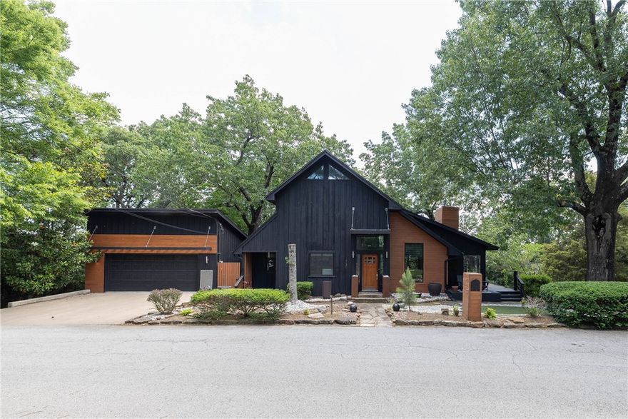 Amazing opportunity to own an ICONIC property on Mt Sequoyah that is situated on 4 lots with incredible views! This meticulously maintained home offers 3,145 heated sq ft, 4 bedrooms, 3 bathrooms, great room open to kitchen, nook, formal dining, bonus room, and laundry. Amenities include quartz counter tops, refrigerator/washer/dryer, NEW Anderson wood windows, screened in patio, basement workshop, gardening shed, detached 2 car garage w/ full storage underneath. The 4th bedroom has built ins for a closet and is versatile for use as a study as well!  All situated on a beautiful park like setting with rock and stone walkways and flower beds.  One of the lots is its own parcel number and one of the last building lots on Skyline Drive!!!  The property backs up to the City of Fayetteville Park lands with complete privacy.