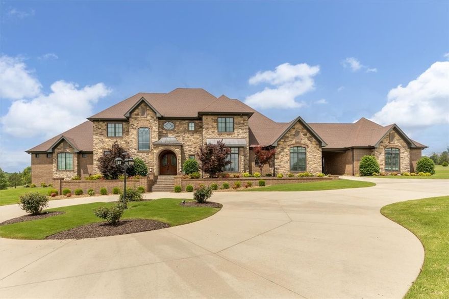 Custom-built 6,400 sq ft home in the desirable Grand Valley Estates, just minutes from Sassafras Winery. Situated on approx. 2 acres, this one-owner home offers 5 bedrooms—including a full mother-in-law suite—& 5.5 baths, thoughtfully designed for both everyday comfort & elegant entertaining. Main living area showcases a true masonry fireplace, custom ceiling beams, & a Juliet balcony that adds charm & character. Chef’s kitchen features Jenn-Air appliances, double oven, pot filler, warming drawer, two sinks, & walk-in pantry with pull-out shelving. Luxurious primary suite is a retreat all its own with two showers, two toilets, dual closets, & a jetted tub, plus direct access to a flex room ideal for an office, nursery, or studio. Additional highlights include a second living room, rich wood-paneled office with built-ins, safe room, central vac, & 4-car garage with RV pad. Outdoors, enjoy a heated saltwater pool, Trex deck with pergola, fenced yard, & more. See attached for full amenities—this home truly has it all.