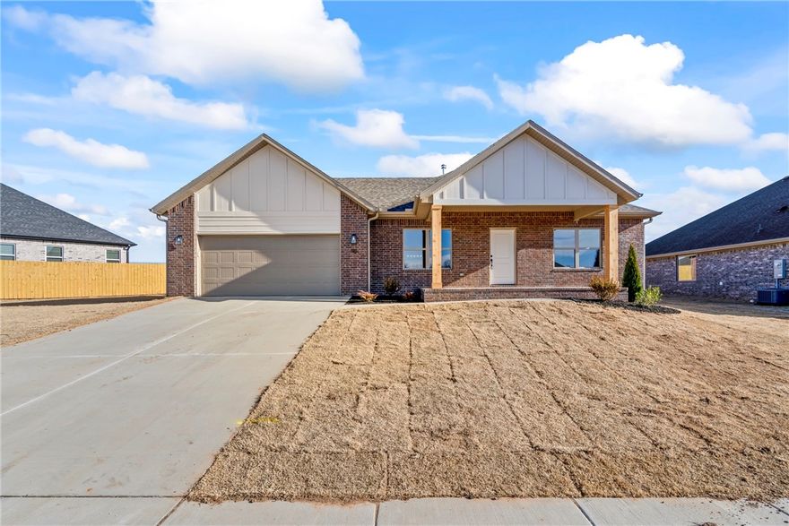 This newly constructed home offers an open-concept living area featuring durable luxury vinyl tile throughout the main living areas and the primary suite. The living room is oversized with a sleek electric fireplace with a shiplap surround, creating a warm yet contemporary focal point. The kitchen is both stylish and functional, showcasing white cabinetry, granite countertops, stainless steel appliances and a large center island with seating. The primary suite includes a spacious ensuite with a granite-topped vanity, black hardware, and a walk-in shower with glass enclosure. Energy-efficient construction, ample natural light, and a covered front and back porch. Located in a growing area with convenient access to local amenities. Blinds, Gutters and a fully sod yard.