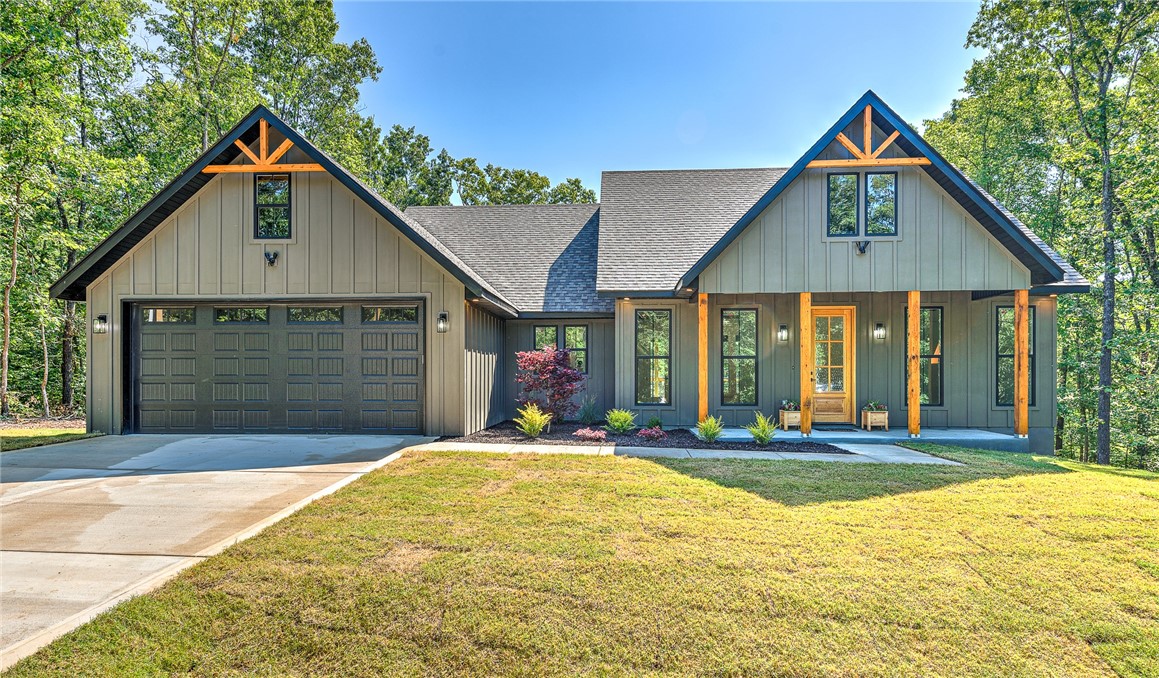 Beautifully designed modern farmhouse with open-concept living and a spacious split floorplan. Features a clean gray and alabaster white color scheme with black accents, 10’ ceilings, custom beams in the living room and primary suite, and oversized 8’ doors. Luxury vinyl plank flooring throughout. The kitchen boasts custom cabinetry, an 8’ quartz island, gas stove, potfiller, and large walk-in pantry with hidden appliance plugs. Enjoy elevated trim, fully cased windows with faux wood blinds, custom closets, and elegant cased openings. The primary bath offers ample storage, and the guest bath includes a tiled shower and custom shelving. Spacious covered front and back patios overlook a professionally landscaped yard with mature pines. Exterior includes gutters with buried drainage and an insulated garage with oversized insulated door. Quiet cul-de-sac location just 3 minutes from Hwy 71, shopping, restaurants, golf, trails, lakes, and more.