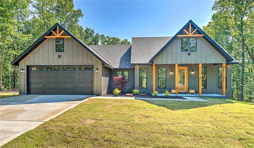 Beautifully designed modern farmhouse with open-concept living and a spacious split floorplan. Features a clean gray and alabaster white color scheme with black accents, 10’ ceilings, custom beams in the living room and primary suite, and oversized 8’ doors. Luxury vinyl plank flooring throughout. The kitchen boasts custom cabinetry, an 8’ quartz island, gas stove, potfiller, and large walk-in pantry with hidden appliance plugs. Enjoy elevated trim, fully cased windows with faux wood blinds, custom closets, and elegant cased openings. The primary bath offers ample storage, and the guest bath includes a tiled shower and custom shelving. Spacious covered front and back patios overlook a professionally landscaped yard with mature pines. Exterior includes gutters with buried drainage and an insulated garage with oversized insulated door. Quiet cul-de-sac location just 3 minutes from Hwy 71, shopping, restaurants, golf, trails, lakes, and more.