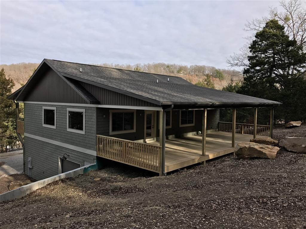 NEW Beaver Lake home completed October of 2016! 30’ slip in 4 slip dock. 1564 square foot garage is heated/cooled and has half bath. 1564 square foot main level. 6’x46’ front deck and 16’x46’ rear deck! Flat back yard for bonfires and outbuilding. Vinyl staggered shake siding for low maintenance. Custom cabinets, 7”x36” wood look tile floors, large windows, granite/marble counters, closets with built-ins. Washer and dryer in master bath. Paved roads, underground electricity, community water. Agent owned.