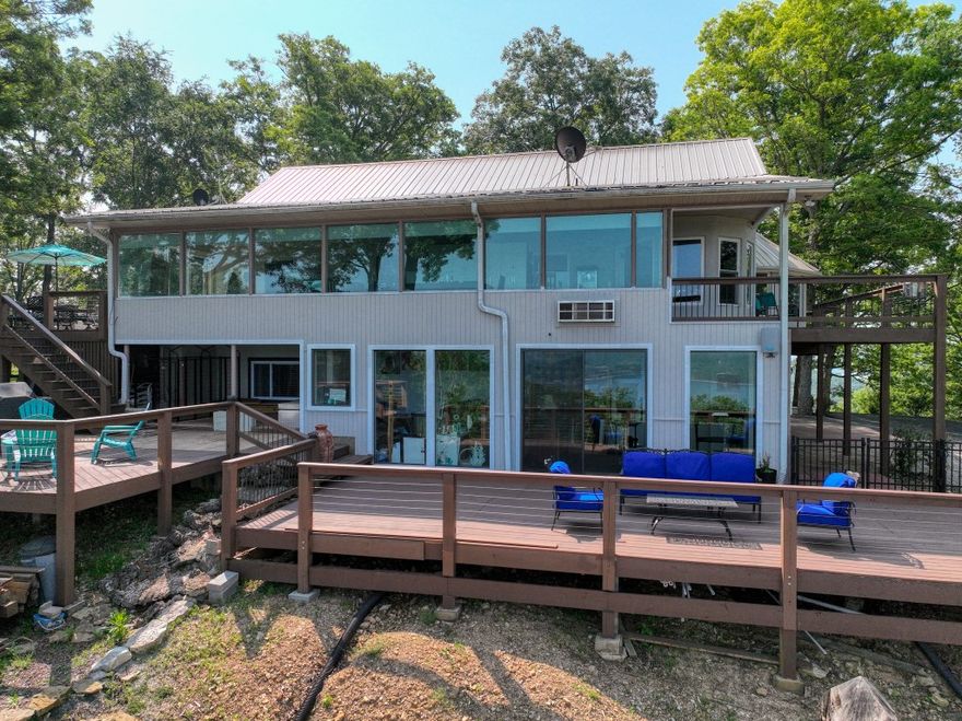 This easy to get to and spacious 3 acre tract in Point Mirage, is on a paved driveway which leads up to the top of the hill for views of Beaver Lake in two directions! This very clean and well-maintained home, has windows throughout so you can enjoy the lake view from almost everywhere inside! Stare at the view for hours and soak in the pleasant and relaxing feel of this home. You’ll love the large sun room with a wall full of windows, and the different levels of decks wrapping around the house, allowing you to choose from many different relaxing spots to spend your time. The living room and gourmet kitchen are open to each other with a vaulted ceiling, a striking rock fireplace, and beautiful wood floors. This home also features a garage and workshop area, hobby and exercise room, lots of storage, fenced side yard, and a RV storage pad with electrical and water hookup. This upscale subdivision is full of impressive homes and is located very close to Starkey Marina! Leased marina slip could transfer to the buyers!