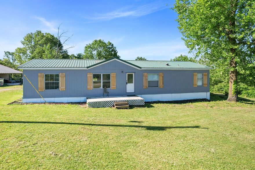 Wonderful home sitting on 3.85 acres! Functional open living space that flows directly into the eat-in kitchen, ideal for entertaining and daily family life. Vaulted ceilings that enhance the sense of space and natural light, complemented by a cozy wood stove, providing warmth and a rustic ambiance. Spacious bedrooms with split bedroom floorplan is highly desirable, offering maximum privacy for everyone. Ideal setting boasting a great balance of mature trees, offering shade and a picturesque backdrop with excellent yard space for gardening, pets, or play. Beautiful views of the surrounding landscape from both the front and back decks with a brand new fence to create privacy. Featuring a 25 X 30 detached garage/shop with a dedicated 8 X 30 lean to, plus an additional carport provides extra covered parking or storage forrecreational vehicles, boats, or trailers. Perfectly positioned for someone who values outdoor living, storage for toys, and a peaceful lifestyle with the convenience of being minutes from the water!
