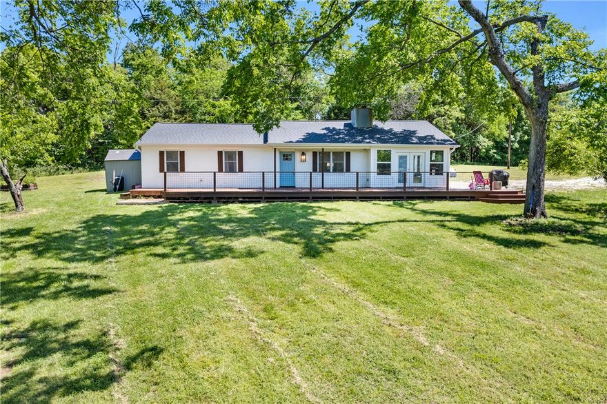 Nestled among the rolling hills of Northwest Arkansas, this stunning retreat offers the perfect balance of privacy, space, and modern comfort — an ideal opportunity for those seeking a luxury rural lifestyle without sacrificing convenience. From the moment you arrive, you’ll appreciate the scenic setting, mature trees and expansive outdoor space that create a true escape from the hustle and bustle. Inside, the home welcomes you with spacious living areas, abundant natural light, and a warm, inviting atmosphere designed for both everyday living and entertaining. An open kitchen and dining area create a wonderful gathering space for hosting family and friends, while a Murphy bed in one of the bedrooms adds flexibility and functionality for guests or multi-purpose use. Located in the charming community of Canehill, known for its rich history and picturesque landscapes, this property delivers the rare combination of peaceful seclusion and accessibility to nearby Northwest Arkansas amenities.