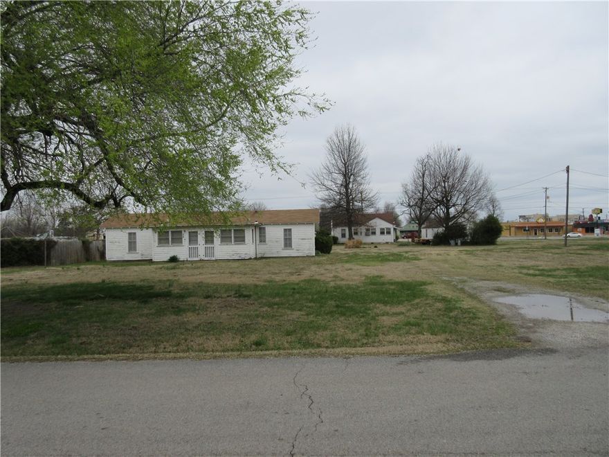 1019 & 1075 West Sunset, Springdale.  Approximately 3.37  Acres Commercial Property. Major road frontage on 412 West(303 ft.) High traffic count. Property also includes 916 & 918 Mayes Ave. (Mayes frontage 238 ft.) This property is excellent for drive thru service windows. Houses on property are of no value. Vacant.