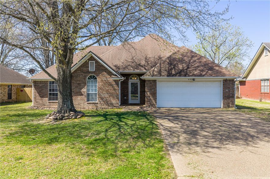 Location, updates, and extra space—this one checks all the boxes! Conveniently located for an easy commute to NWA or Ft. Smith, this 3-bedroom, 2-bath brick home in a well-established neighborhood offers comfort and versatility. Step inside to soaring ceilings, new vinyl flooring, and a split floor plan that gives the primary suite added privacy. The spacious primary bedroom features a large walk-in closet and room to relax. The kitchen offers a pantry, ample storage, and refrigerator that conveys. A sunroom adds bonus space perfect for morning coffee, reading, or entertaining year-round. Outside, the large privacy-fenced backyard provides room for pets, play, and gatherings, plus a detached brick workshop with electricity—ideal for hobbies, storage, or a home office. Major updates include HVAC and water heater (3 years old) and roof replaced in 2018. Security system and Ring doorbell remain. Homes like this are hard to find—schedule your showing today!