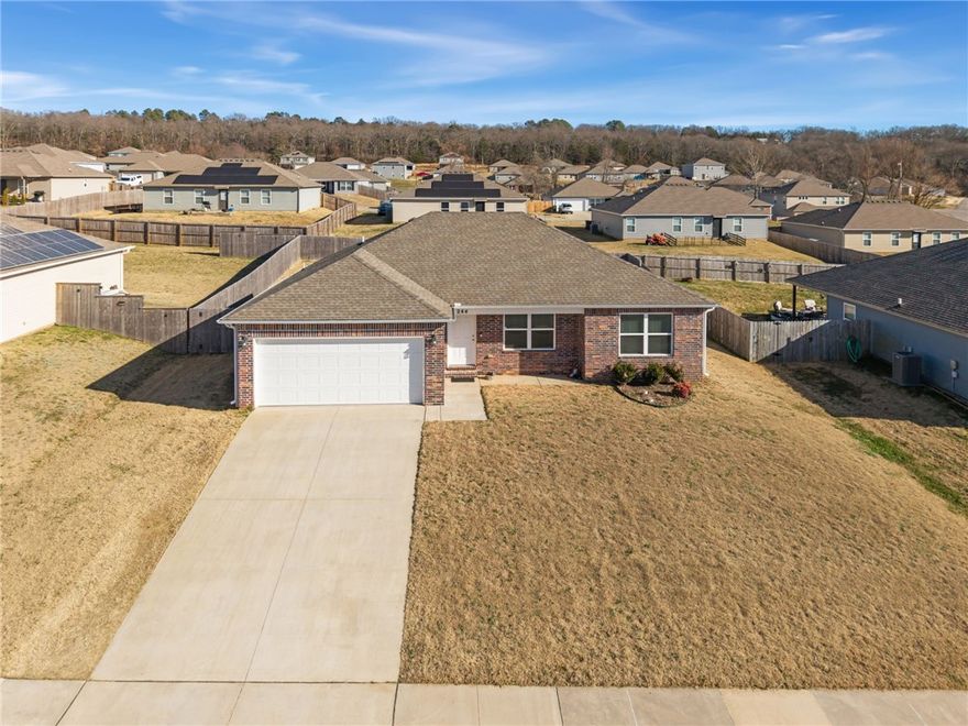 A new home for the new year! Enjoy this home within city limits only steps from shopping, amenities, and the highway providing convenient access to NWA, while also minutes from state parks, hiking, and kayaking opportunities. This immaculate and perfectly maintained home is waiting for you. This home has many upgrades that add to the comfort and beauty of the home. LVP throughout the main living area and the primary suite, high ceilings, and stainless steel appliances are just some of the features inside. When you enter the primary suite the large room and bathroom featuring garden tub and double vanity will transport you to a luxurious escape. The other 2 bedrooms and bathroom are spacious and functional. In the backyard you will find a large deck perfect for entertaining or enjoying the beautiful weather as well as a storage shed, matching the color and style of the home! In the 2 car garage you will find a storm shelter that is rated to withstand an F-5 tornado - included in a full price offer!