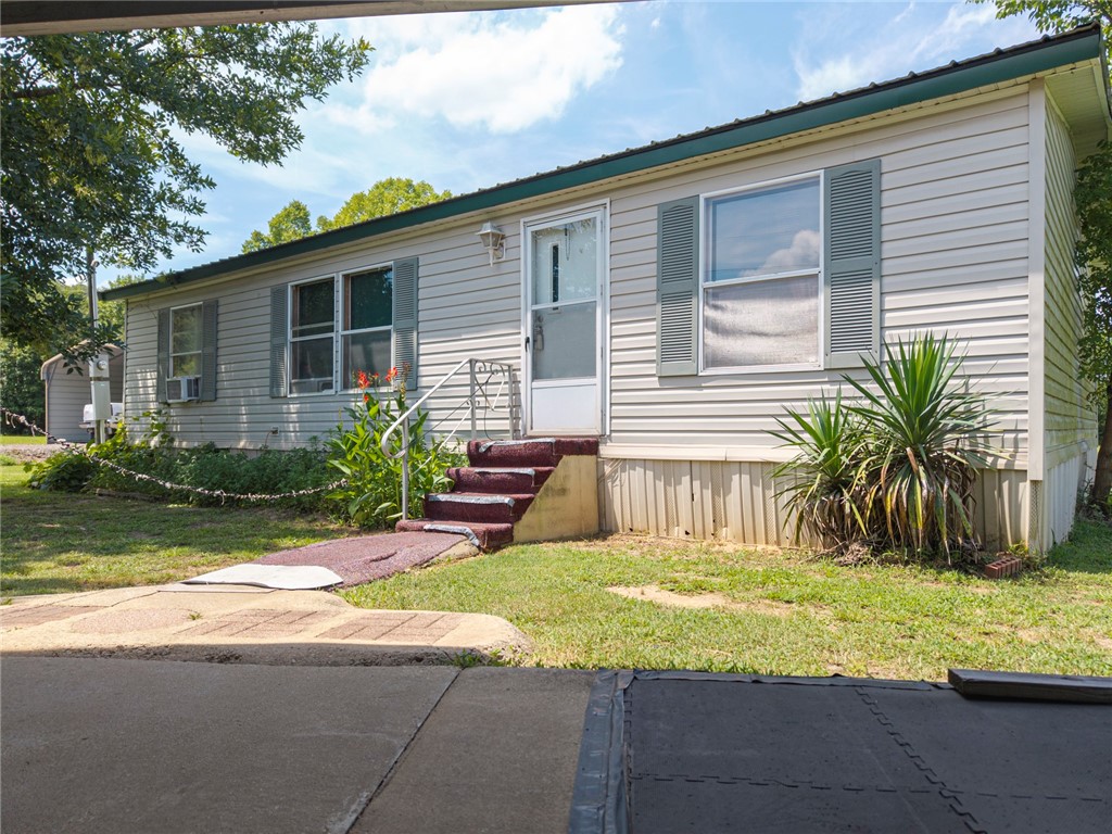 Charming Country Living on Nearly an Acre!
This peaceful rural property offers endless potential—whether you’re looking for a place to call home or a solid investment opportunity. Nestled on approximately 0.94 acres, this 3-bedroom, 2-bathroom doublewide manufactured home (2000) provides comfortable living with room to grow.
The spacious living room features an electric fireplace, perfect for cozy evenings. The eat-in kitchen includes a pantry and plenty of space for casual dining. A durable metal roof was installed around 5 years ago, offering long-term protection and value.
Additional features include an 11’ x 8’ well-maintained storage building and a 2-car carport situated on a concrete pad—ideal for your vehicles or extra storage.
Home is being sold as-is, just needs some TLC. Don’t miss this affordable opportunity to enjoy country living.