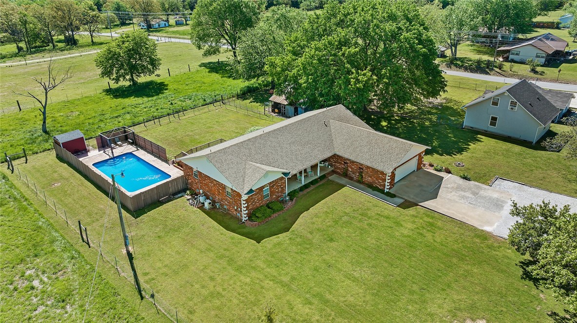 This property offers countryside living on 5.60+/- acres and it is just moments from town. The spacious 2265 square foot home that features a split floor plan with three bedrooms and two bathrooms. Step outside to an inviting heated inground pool, a large deck for outdoor dining and relaxation, and a spacious two-car garage for convenience and organization. Additionally, a charming barn, open field, and a pond further enhance the property's appeal. This property is a unique opportunity to enjoy both rural living and close-to-town convenience.