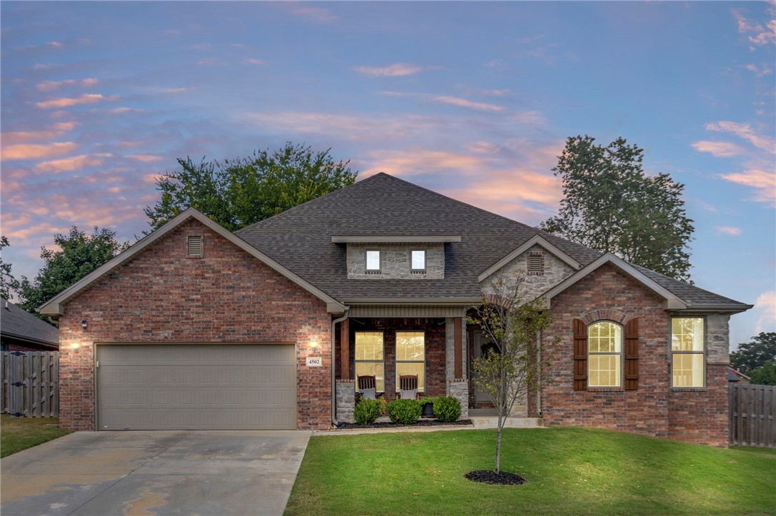 Welcome to this stunning, all-brick 4-bed, 3-bath home in sought-after Willowbrook Farms, where charm and convenience meet. Neighborhood perks include 14+ acres of greenspace, pool, and dog park. Conveniently located just minutes from Downtown Bentonville, Pinnacle shopping area, and the Airport. With over 2,600sqft, this bright and airy home offers a split floor plan with a spacious living area, tall ceilings, wood-look tile, and a cozy brick fireplace. The chef’s kitchen boasts a large island, quartz counters, gas cooktop, under-cabinet lighting, walk-in pantry, and abundant storage. The formal dining room or office adds flexibility for work or entertaining. Retreat to the owner’s suite with dual vanities, soaking tub, and two walk-in closets—one with direct laundry access. Another bedroom features its own ensuite bath, perfect for guests. Outside, enjoy the oversized fenced yard, extended patio, and covered porch- ideal for entertaining. Bonus: shed, blinds, refrigerator, washer/dryer convey. Playset negotiable.