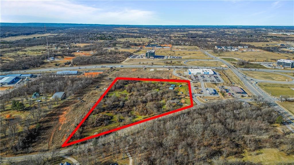 Value is in land, but there is an home and outbuildings for Horses onsite. Amazing commercial land available for prime development opportunity. This 10.55 acres would be suitable for Commercial or multi family development. Conveniently located next to Walmart Neighborhood Market and Caseyās General Store with close proximity to Arkansas Children's Hospital, Arkansas Natural's Baseball, Sam's Club and several restaurants. Directly in between Fayetteville and Rogers, youāre right in the middle of the sought after NWA community Buyer will have access to the gravity sewer line to be installed along the western border. Buyer to confirm all items during due diligence period Also listed as Land MLS# 1319441