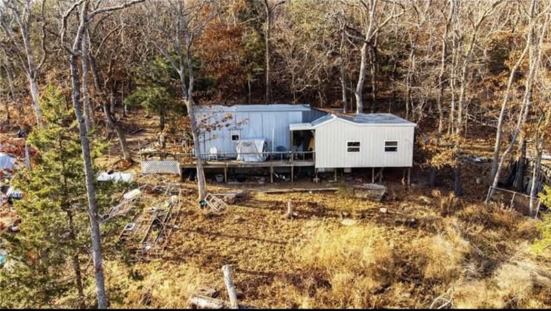 Escape the city life and enjoy nearly 7 beautiful acres in the Ozarks. This home is 1151 sq ft and is surrounded by mature trees of many species including Oak, Walnut, Maple and Cedar. Beautiful rock ledges. Enjoy nature and peace and quiet. The property is outstanding for hunting and is abundant with white tail deer and turkeys. The property also has a new well and septic system, and a metal shop for storage. This property is perfect for anyone wanting to get away from the city, but is close the the essentials as well. Also could serve a a perfect weekend retreat or second home. Tear down or finish the projects needed in the home. Your Ozarks escape awaits so don't miss this wonderful property. Road is rough. Will need AWD or 4WD. Shown by appointment only.