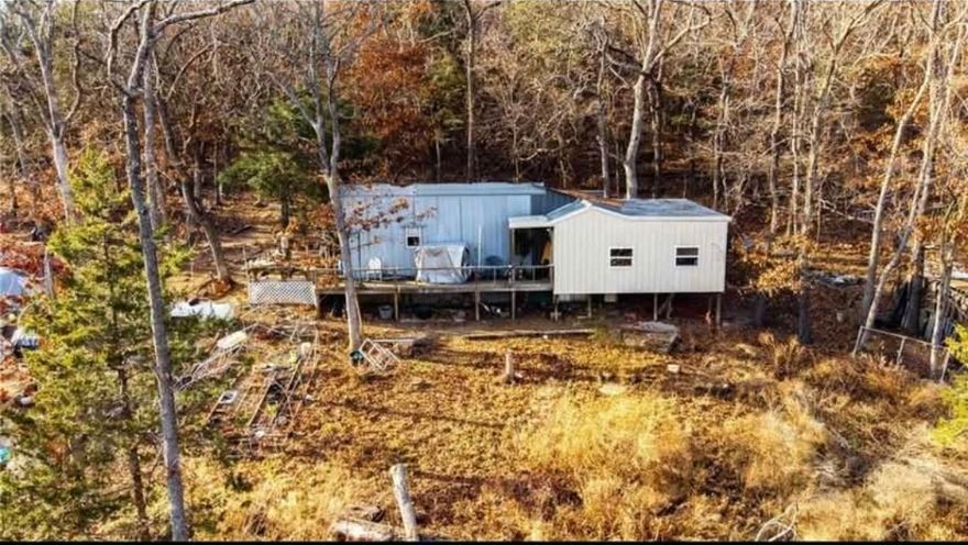 Escape the city life and enjoy nearly 7 beautiful acres in the Ozarks.  This home is 1151 sq ft and is surrounded by mature trees of many species including Oak, Walnut, Maple and Cedar.  Beautiful rock ledges.  Enjoy nature and peace and quiet.  The property is outstanding for hunting and is abundant with white tail deer and turkeys.  The property also has a new well and septic system, and a metal shop for storage.  This property is perfect for anyone wanting to get away from the city, but is close the the essentials as well.  Also could serve a a perfect weekend retreat or second home.  Tear down or finish the projects needed in the home.  Your Ozarks escape awaits so don't miss this wonderful property.  Road is rough.  Will need AWD or 4WD.  Shown by appointment only.