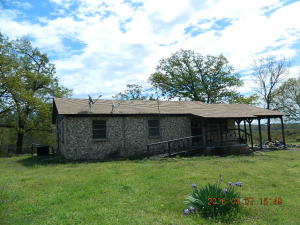 Cattle Farm. 38.38 Acres. (originally listed with 200 Acres) 3 stock ponds, barbed wire fencing & paved rd. frontage w/ easy access toInterstate 40. Rustic farm home included w/ wagon wheel porch railing, wooded beams and fresh paint and new flooring throughout. Working pinsby home, grain bin, and large equipment shed. Bring the tractor and the livestock and begin operation immediately. R