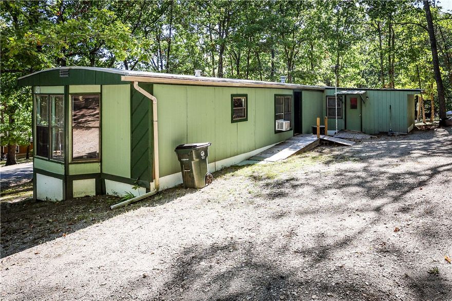 Corner lot with a mobile home in unit 1 holiday island Arkansas.  Great location .