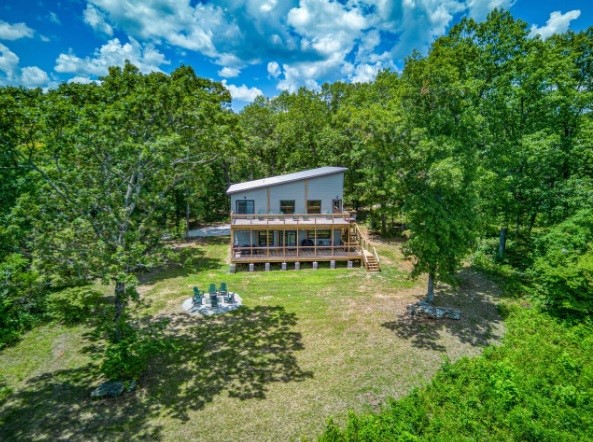 “Wake up to Nature – 37 Acres with 3 cabins Bordering the Buffalo National River” Experience the perfect blend of industrial design and cozy cabin comfort with this newly custom-built retreat. This property consists of 3 homes, with gated access, nestled on 37 secluded acres with Hoskin Creek running through and bordering the Buffalo National River Parkland, in the Marble Falls/Erbie area, in Newton County. The main home consists of spacious 3-bedroom, 3.5-bath, offering 2,600 sq. ft. of thoughtfully designed living space with breathtaking views. Also located on the property are two additional converted 8’x40’ container homes (330 sqft) wired for backup generator and are currently being used as nightly rentals. Each home located on the property has its own access to county water, electric, and septic. Whether you're seeking adventure or tranquility, this property could be your ideal escape.