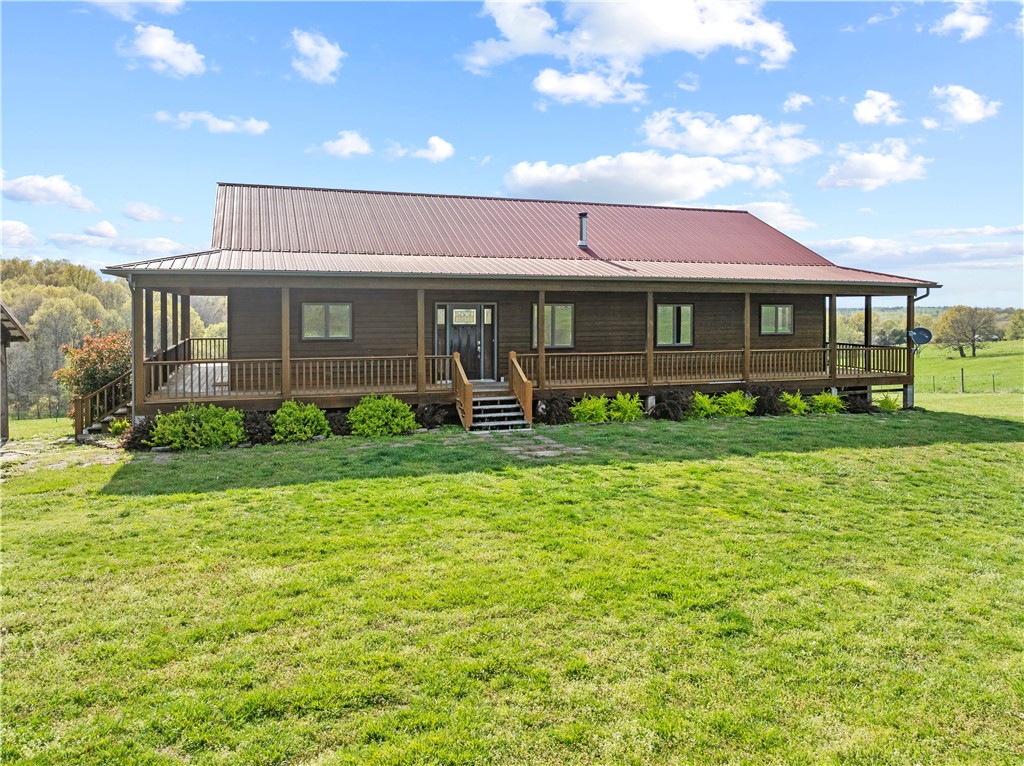 Discover the perfect blend of comfort, style, and functionality on this stunning 56.2-acre property nestled in the heart of the Ozarks. This spacious 3-bed, 3-bath home offers 3,480 sq ft of beautifully designed living space, including a fully finished basement—perfect for a second living area, entertainment space, or guest suite.
The heart of the home is the chef’s kitchen, featuring high-end finishes, a large center island, and ample room for hosting friends and family. Natural light pours in through premium Andersen windows, showcasing the scenic views that surround you.
Step outside to find a property that’s both peaceful and practical. Whether you're a hobbyist, homesteader, or simply enjoy wide-open space, you’ll appreciate the workshop, greenhouse, and gently rolling acreage ideal for animals, gardening, or future expansion. This one-of-a-kind property offers the space, privacy, and versatility you've been searching for—all just a short drive from the amenities of Harrison.