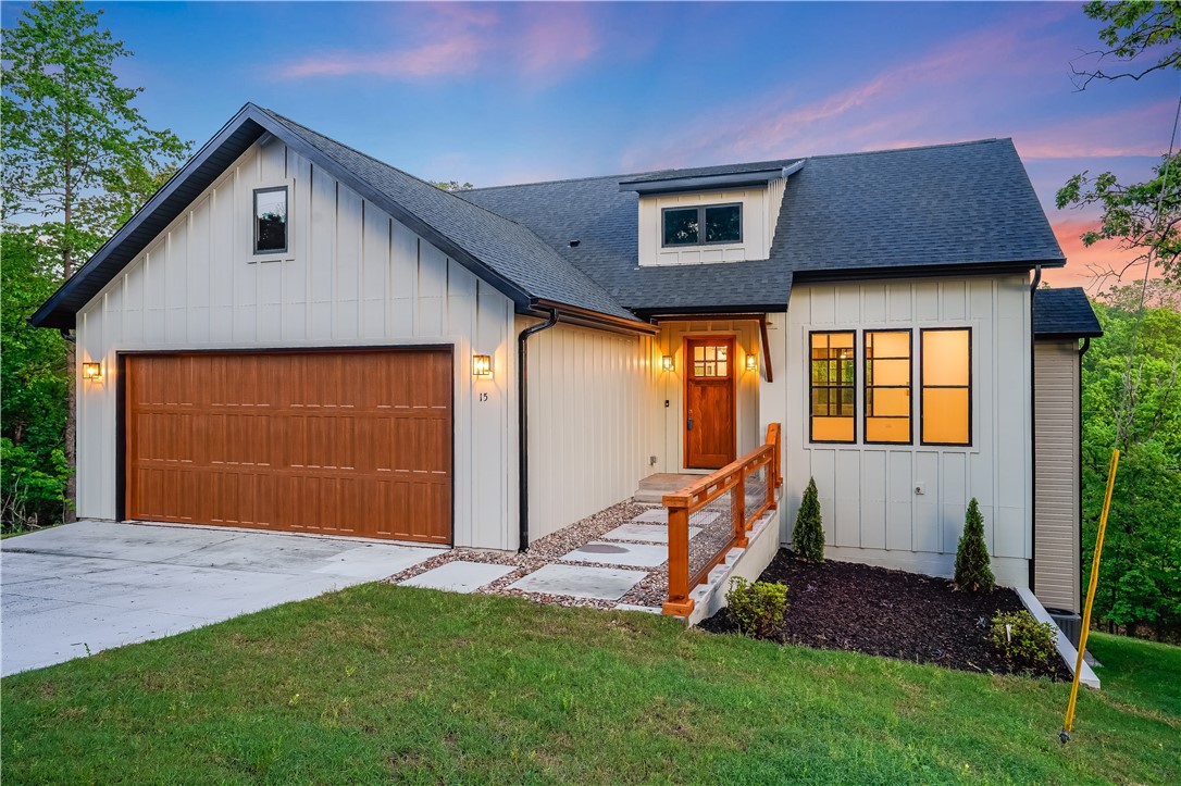 Experience the perfect blend of luxury, comfort, and natural beauty in this stunning Bella Vista home—just moments from world-class biking, golf, and serene surroundings. Thoughtfully designed, the great room impresses with rich wood beams, a striking board and batten accent wall, and an elegant electric fireplace. A statement office with glass windows offers the ideal work-from-home retreat. The spacious primary suite features his-and-hers closets and a beautiful tray ceiling. Two living areas, two decks, and a walkout basement provide incredible space for entertaining or relaxing. Double-paned Marvin windows, 5th Gen Nest smart thermostats, and a 220 EV charging port elevate both efficiency and comfort. A one-year mechanical warranty adds peace of mind. Just 0.2 miles from Tunnel Vision trail, 2.4 miles from Kingswood Golf Course, and 10 minutes to I-49—live the Bella Vista lifestyle surrounded by beauty, recreation, and endless possibilities.