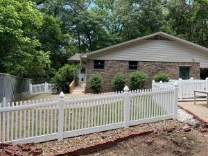 Beautifully appointed home offering seclusion, but conveniently located minutes from town. Adjacent to the golf course (no direct cart access), and nestled in a wooded area with minimal lawn care requirements. Gorgeous granite countertops and cabinetry in kitchen and bathrooms.