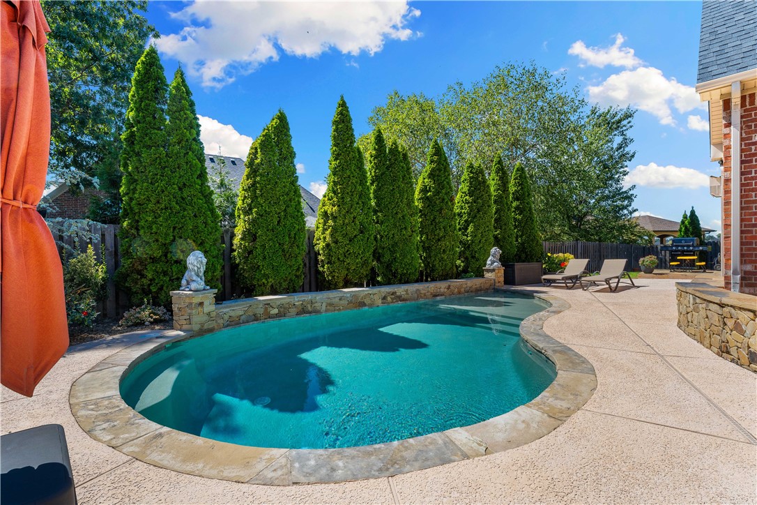 STUNNING, CUSTOM HOME in the HIGHLY SOUGHT-AFTER GATED COMMUNITY OF SHADOW VALLEY situated on a tranquil cul-de-sac. This meticulously maintained home features 4 bedrooms and 4.5 baths showcasing a superbly designed open floor plan with impressive high ceilings in the main living room along with its breathtaking wall of windows. Lots of cooking space in the chef's kitchen. Kitchen features include quartz countertops, a large island, a new Viking Gas Cooktop, double ovens, a pantry, and a new beverage cooler for all your entertaining needs. The kitchen seamlessly flows into the second living room with its beautiful fireplace. The private primary suite offers an ensuite that has heated floors and a walk-through shower. It also includes an office nook with built-ins connecting to the study/den with a fireplace. Upstairs, you'll find three spacious bedrooms, each with its own ensuite bath. The backyard is a true retreat which offers a covered patio and private heated in-ground pool.