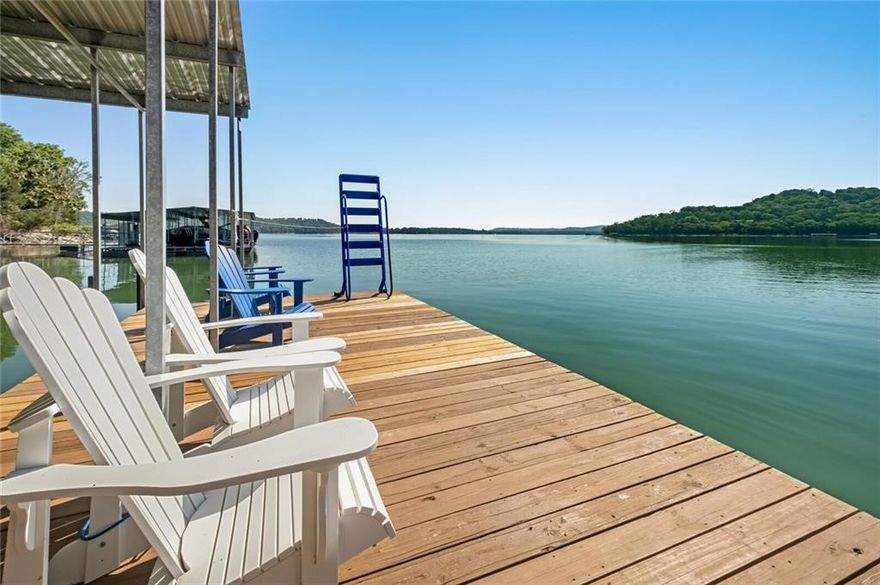 Amazing home and location on this 1.16 acre Beaver Lake waterfront retreat! The expansive property includes mature trees, paved golf cart path to the corp line for easy access to the lake, with a private boat dock and permitted for 4 slips (two for boats and two for jet skis), large swim deck and is solar powered! Located along a peaceful cove with breathtaking Beaver Lake views off the great room and a newly added screened-in porch. Open Floorplan with main level featuring 3 bedrooms, 2 full baths & vaulted wood-beam great room that opens to the kitchen & dining areas. The lower level houses a spacious 2nd living area or fun bunk room, full bath & generous laundry room. Conveniently located 10 minutes from downtown Rogers & offers plenty of space for guests w/oversized 2 car garage & extra parking pad!  Wal-Mart and InstaCart delivers here for your convenience too!  Home to sell fully furnished.