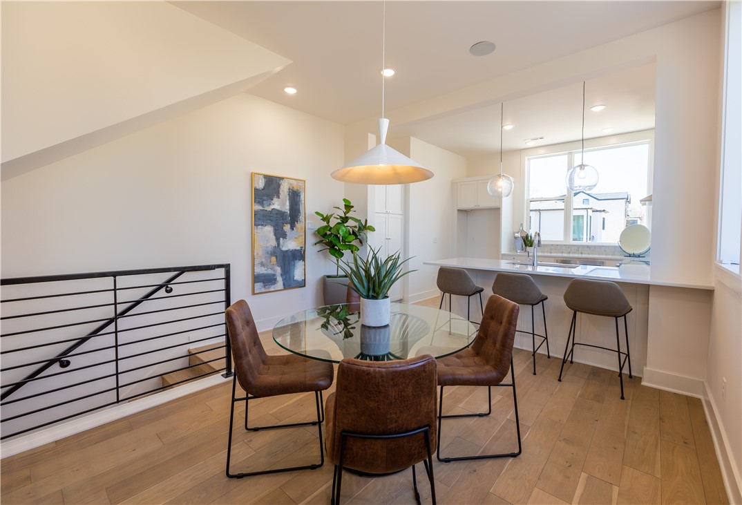 In the heart of downtown. This townhome boasts a variety of amenities such as an open floorplan design, architectural detailing, outdoor patio, slab quartz countertops, tile backsplashes, hardwood flooring, full tile showers, GE appliances, and a single car garage. Located just next to the downtown Skylight movie theater, and an easy walk to the Bentonville square, Walmart home office, the Momentary museum, and local shops and restaurants.