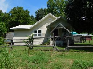 Enjoy Country Living - great little Farmette with nicely updated home and 8.41 acres Plus 24x30 ft shop, a 3 stall carport/equipment shed, & a wood frame shop bldg. Home renovated in 2009 with large addition, metal roof, Hardyboard siding, new windows, kitchen, baths, floor coverings, and more. Main floor includes open living area, bamboo wood flooring, native stone hearth & wood stove, kitchen/dine combo with new cabinets, Corian counter tops & sink, spacious master bedroom & bath with oversize shower, 2nd floor has landing area, 2 extra bedrooms and attic storage room. Land has southern exposure, about half pasture and half wooded, fenced, great for cows or horses. Deer, turkey & other wildlife seen regularly. Located on paved road about 20 minutes to Harrison or an hour to Fayetteville.