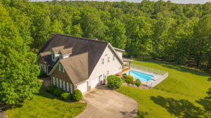 Wonderful secluded estate on the outskirts of Harrison. Executive style custom built home is situated on 13+ acres on a paved road, yet only minutes from town. Interior of home features tall ceilings, open floor plan, private master suite with new private deck, over 3800 sq ft, 5 bedrooms, 4.5 baths, separate dining room, two wood stoves, workshop, man cave, den, safe room, and office. Exterior features a paved circle driveway, pretty views of surrounding areas, in-ground heated pool, covered front porch, new covered back deck, and lots of wildlife! See Supplement for more information.