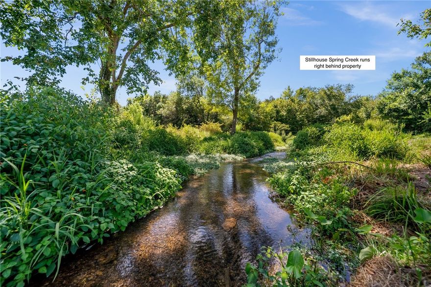 There is absolutely nothing like this neighborhood in all of Northwest Arkansas! This 1.98 ac mostly level property is surrounded by the Arkansas Natural Heritage Preserve and the Stillhouse Spring Creek (not on property but accessible). Set back from the cul-de-sac means privacy in a park like setting perfect for an estate. Public electric, gas, and water. Bentonville schools! Choose your own builder to build your dream home! More information including specifics to this lot, building requirements, and disclosures available.