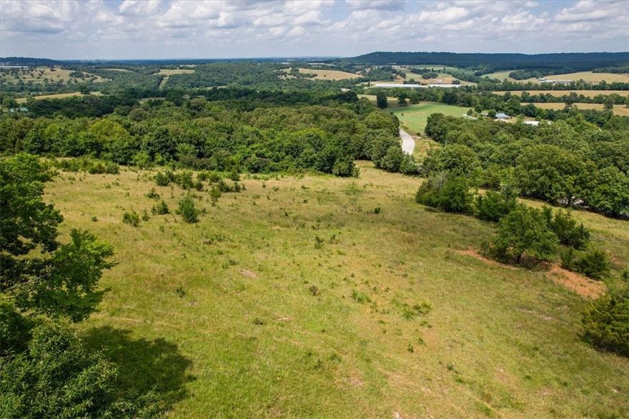 Escape to your own private slice of the Ozarks! This breathtaking 10.01-acre (m/l) property offers endless possibilities—build your dream home, create a hobby farm, or simply enjoy the peace and wide-open beauty of rural Madison County. Gently rolling terrain, partial fencing, and sweeping hilltop views set the stage for your next adventure. Power is available at the street,  A septic system will be needed. Conveniently located just minutes from Goshen and Huntsville, with easy access to Hwy 45 and Hwy 412. Come experience the tranquility, fresh air, and room to grow—your countryside escape awaits!