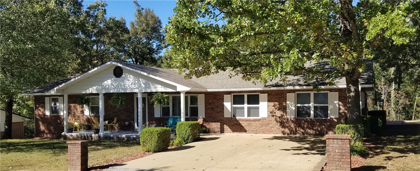 Reduced! One look at this beautiful brick home & it's obviously quality constructed w/ 2x6 walls & well taken care of. Spacious living room w/ gas log Fireplace & newer carpet. The garage conversion makes a huge private master bedroom w/ double closets, jacuzzi tub, & 3/4 bath. Three other bedrooms located on the other end of the home(w/ new carpet and laminate wood flooring) plus two more tiled baths allow for a big family or extra space. The kitchen has a breakfast bar & is loaded with charming cathedral style cabinets. The separate dining area leads you out through a patio door to the new wood deck w/ wooded privacy & enough space for large get-togethers. Tons of storage space for cars, toys, & misc. w/ the 2 car garage(new doors/openers) plus work room & the 12x24 metal out building in the back yard. This home has a newer architectural shingle roof & a new HVAC system last year & new hot water heater. Within an hours drive of Branson, Mo., Fayetteville, Springdale, Bentonville, corridor & NWA Regional Airport.