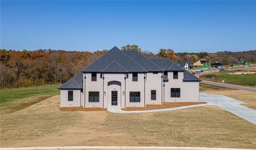 Beautiful new construction home in East Fayetteville’s Asher's Ranch S/D with incredible views! 3,520 heated sq ft offers 4 bedrooms, 4 full baths, oversized eat in kitchen open to living, study, laundry, and bonus room. Other amenities included are painted brick exterior, large covered patio, waterfall quartz island, built in SS double ovens, microwave in the island, 5 burner gas range, pot filler, large walk in panty, designer fixtures, walk in attic storage, and a 3 car garage. All situated on a corner lot. Home is zoned for Vandergriff.